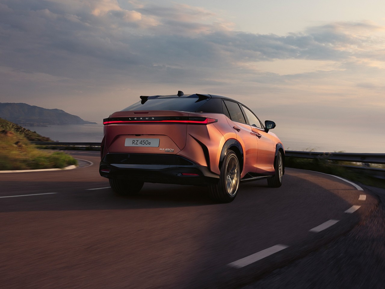 Lexus RZ driving on a coastal road